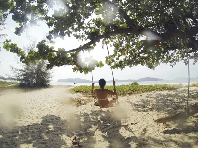 tropical-beach-woman-on-a-swing