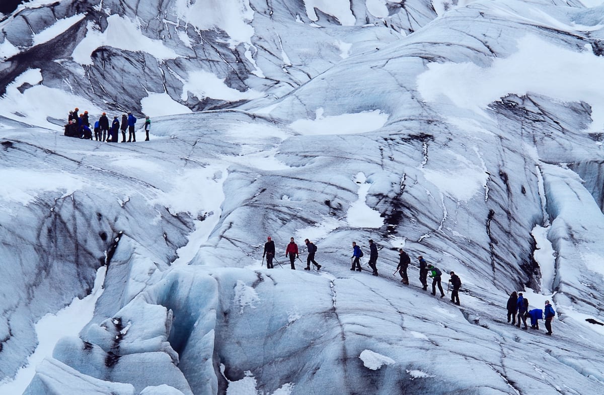 people hiking on large Iceland glacier