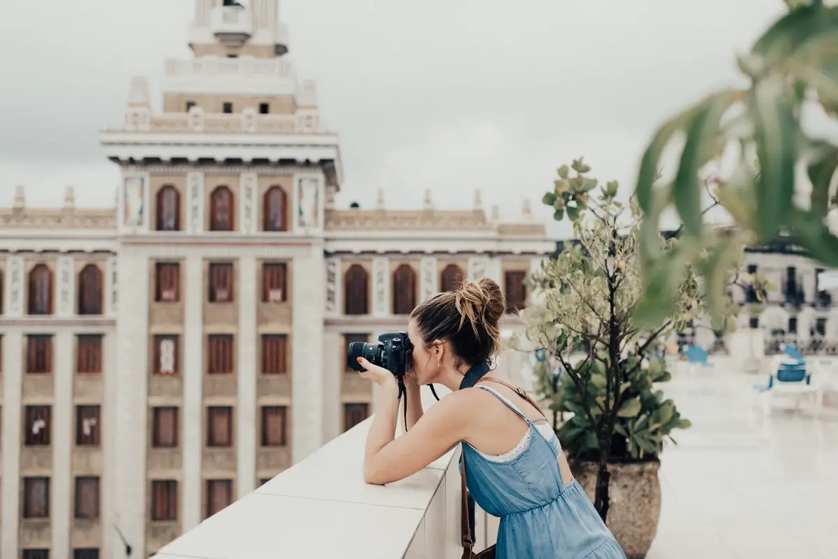 girl-taking-picture-with-camera-in-cuba