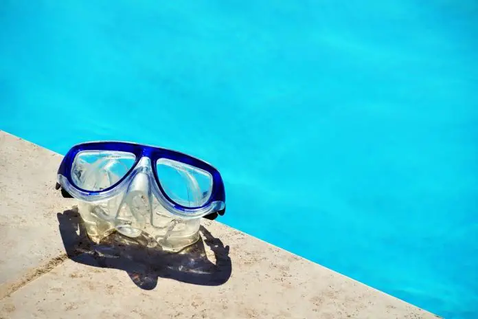 Dive mask on edge of pool
