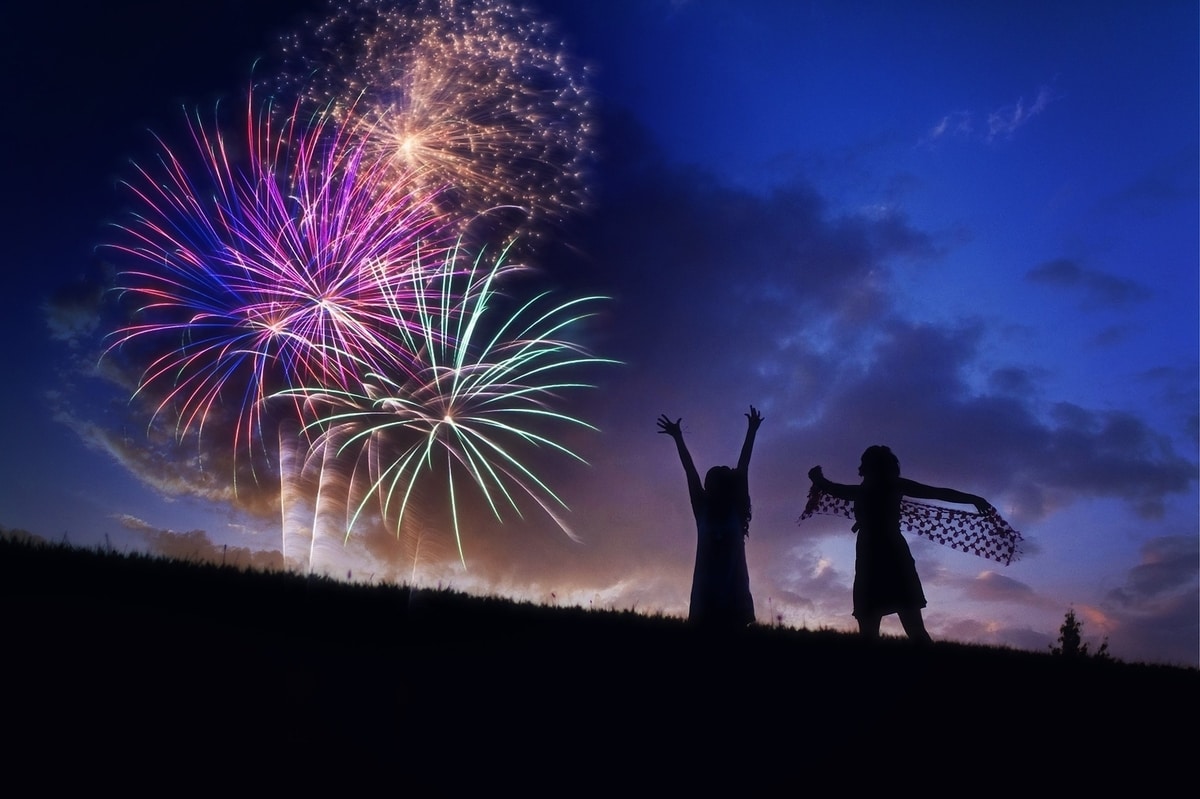fireworks-at-night-while-people-dance-on-a-hill