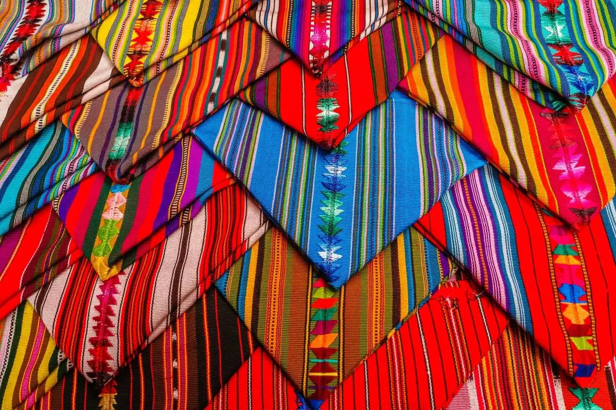 Brightly coloured embroidered textiles at a market in Guatemala