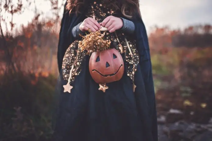 Girl holding halloween pumpkin