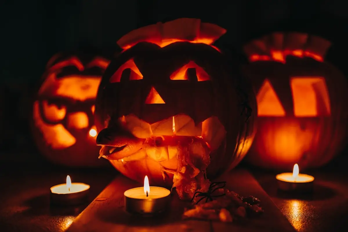 Halloween jack o'lanterns lit by candles