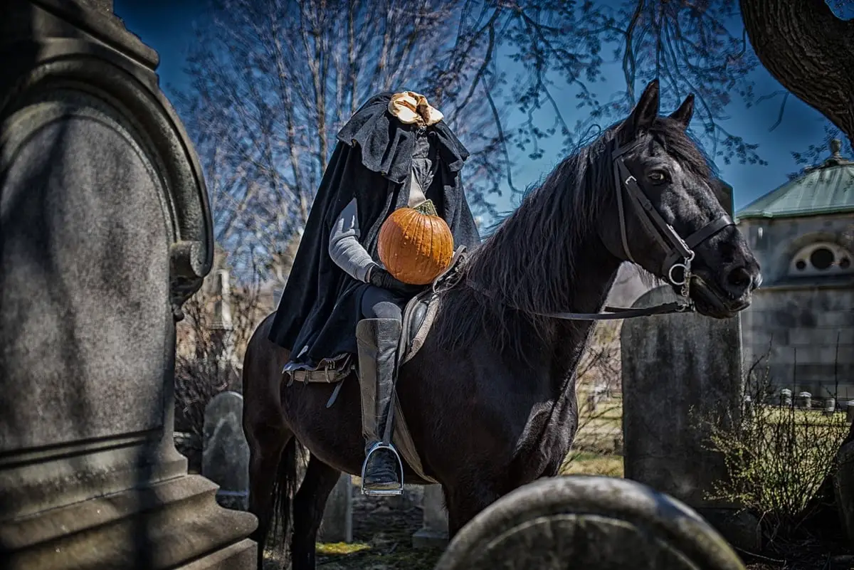 The headless horseman sitting on his horse in a graveyard in Sleepy Hollow