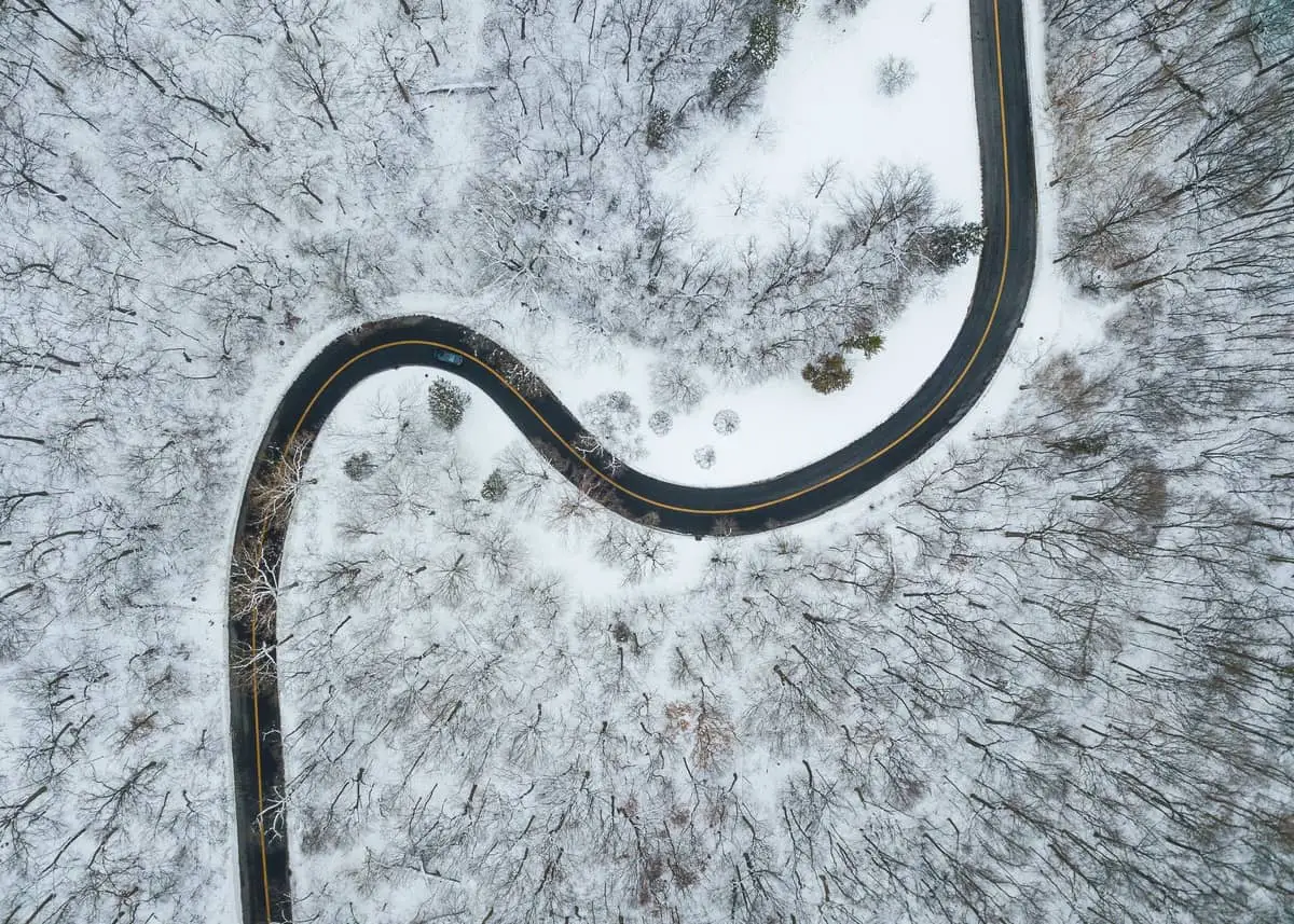 Aerial view of road in middle of snow and trees in Peoria, Il