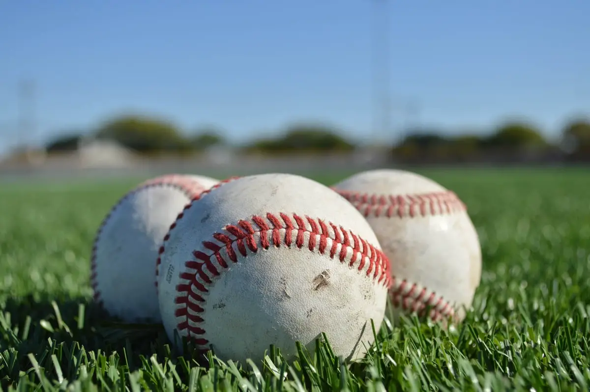 Three baseballs sitting in grass in Illinois