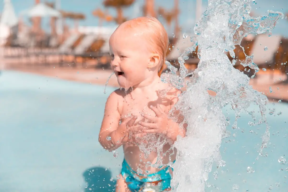 Baby playing in water at waterpark